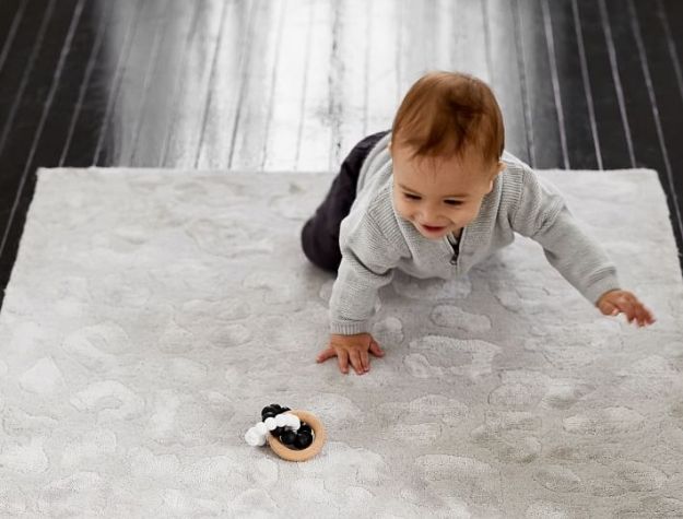 baby playing with teether toy