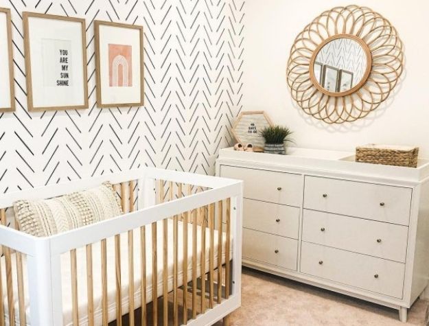 modern girl nursery with crib and changing table