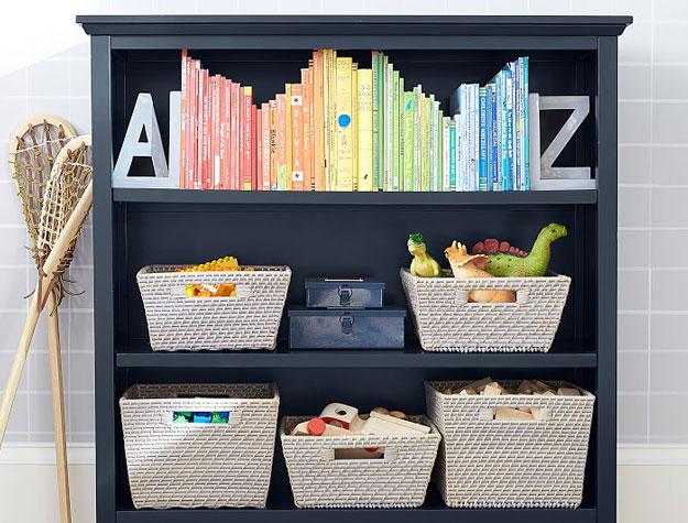black bookcase with bins and books