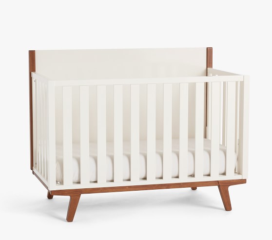white crib with wood legs