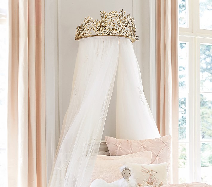 A bed canopy with gold vine cornice around the top
