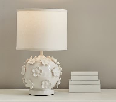 white ceramic lamp with flower on base