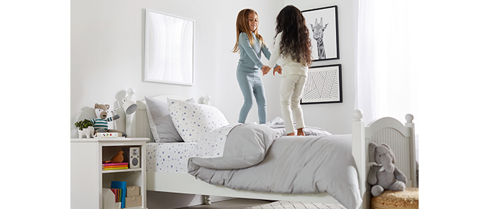 Two sisters playing in their new room.