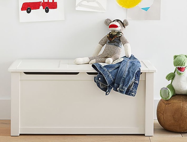White toy box with a stuffed monkey on top