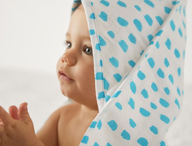 baby in speckled hooded towel