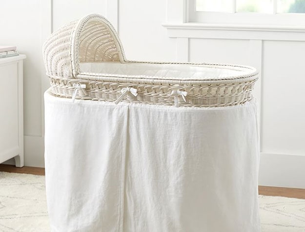 white rattan bassinet with braided detail