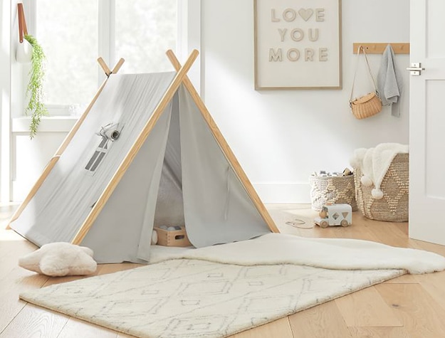 Child’s tent and plush white rug with diamond pattern
