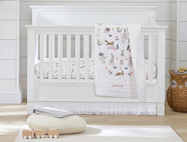 Baby crib with toys and blanket