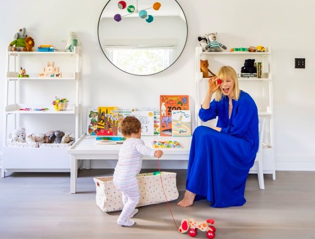 Mom in blue dress and baby play together