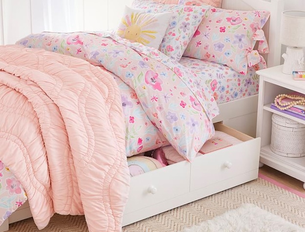 White twin bed with drawers underneath