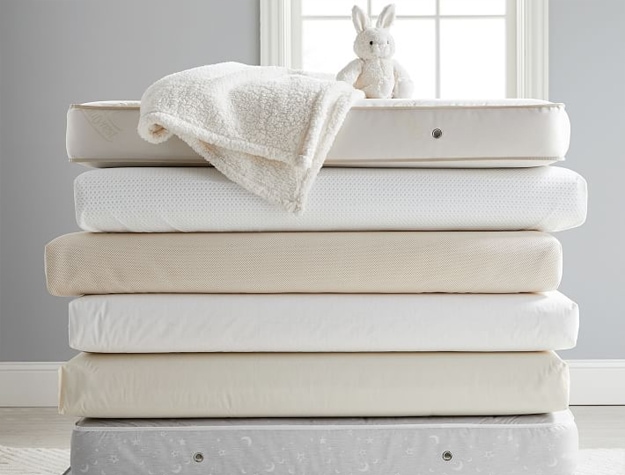 Stack of various types of crib mattresses