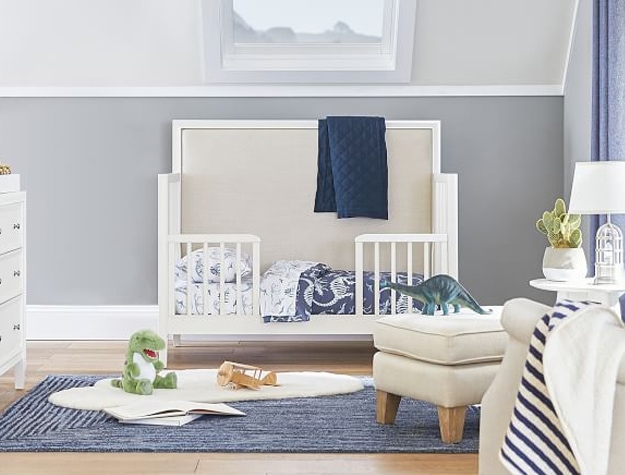 Boys’ nursery room with convertible crib