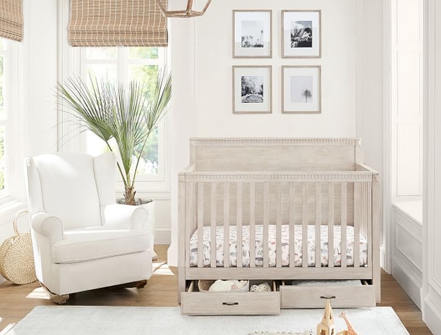 Beautiful nursery with wood crib and chair