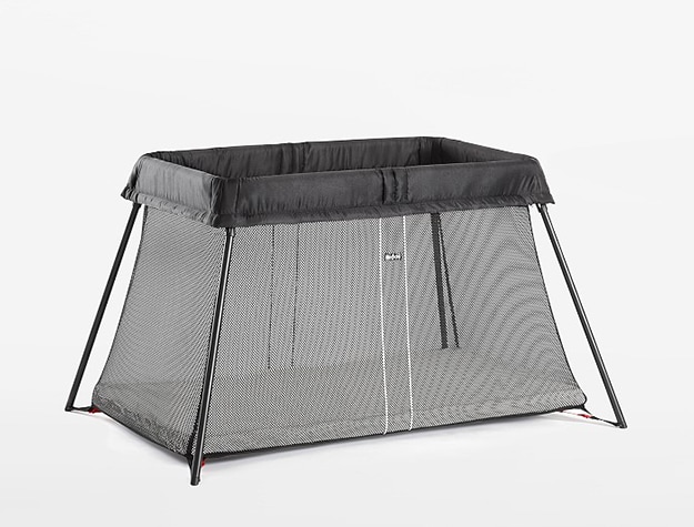 Black travel crib with mesh sides