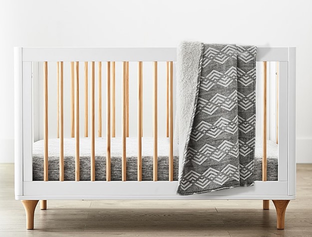 White crib with wood rods