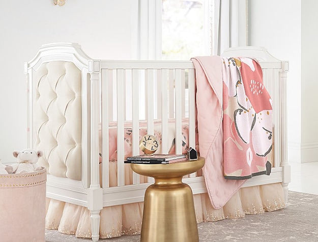 Upholstery sided crib with pink accents