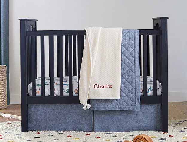Navy blue crib in nursery