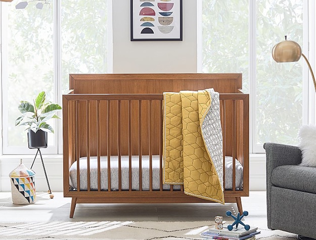 Mid century wood crib with blanket
