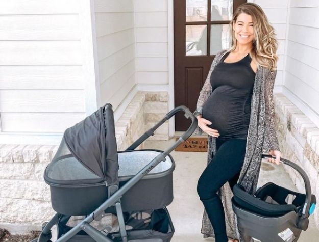 expecting mother with stroller and car seat