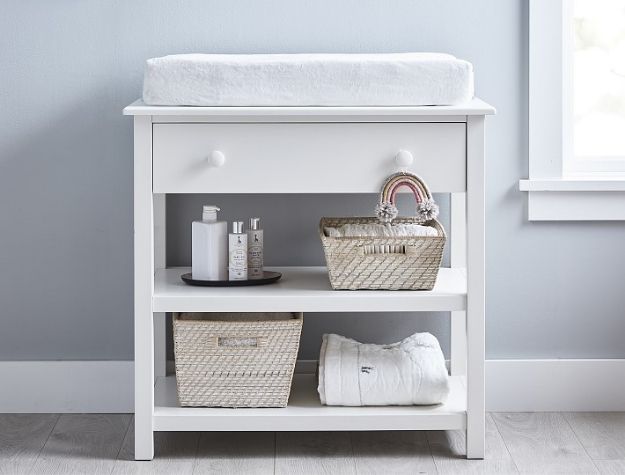 small white changing table with cover