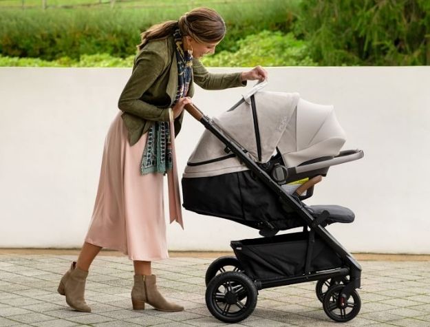 mother smiling at baby through stroller window