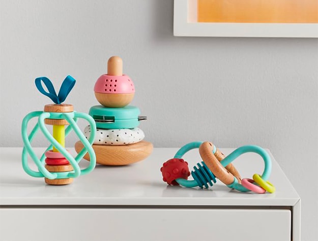 Colorful children’s toys on white dresser