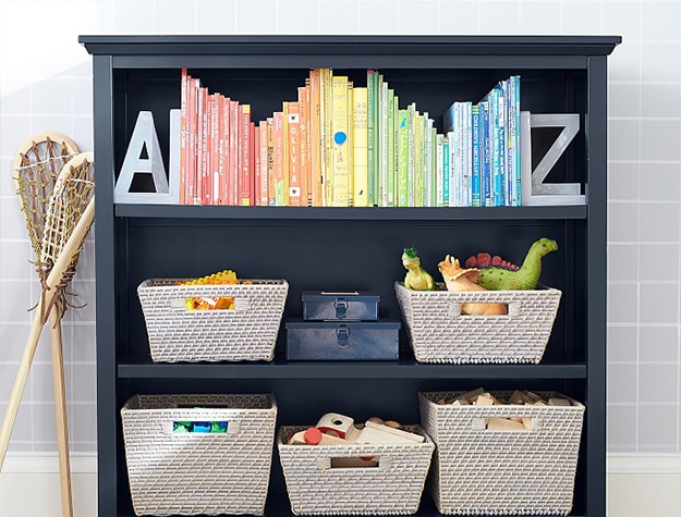 Black open shelf bookcase with wicker storage containers