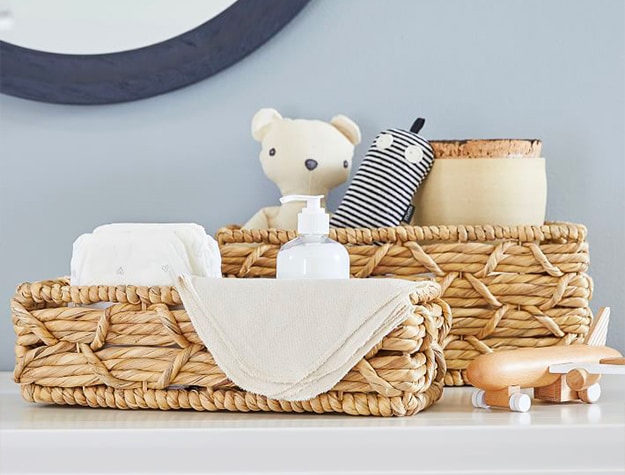 woven seagrass baskets with teddy bear and airplane decoration