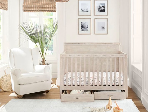 White washed crib with drawers underneath 