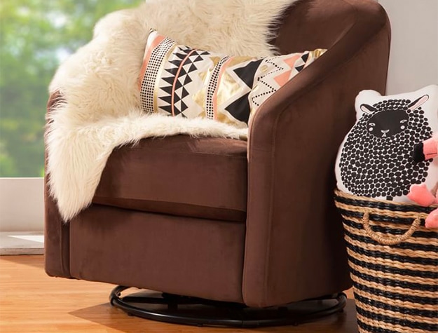 brown suede swivel chair with white faux fur blanket