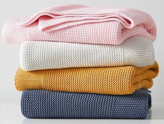 pink, white, yellow and blue knitted blankets