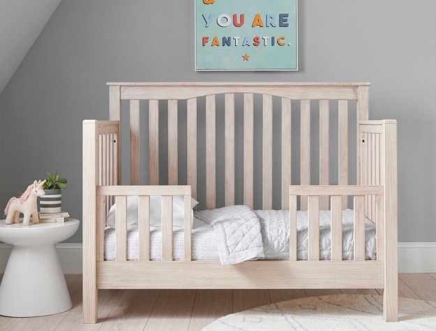 Tan wooden toddler bed