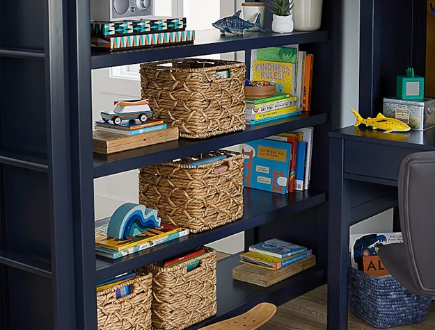 Navy bookshelf with books and baskets