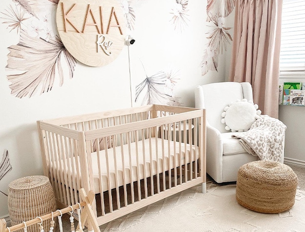 Modern nursery with wall hanging reading Kaia Rose.