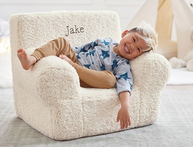 child sitting in personalized blush chair