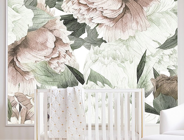 Floral wallpaper with gold mirror and white crib.