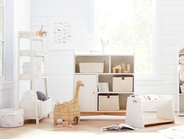 Various storage supplies in brightly lit child’s bedroom.