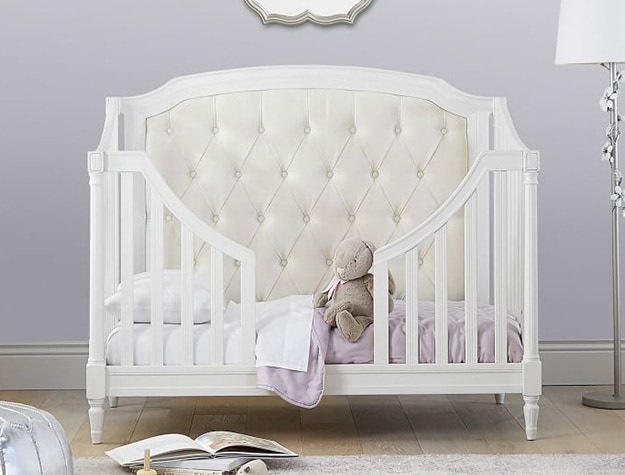 White blythe 3 in 1 toddler bed and conversion kit with stuffed animal and purple accents.