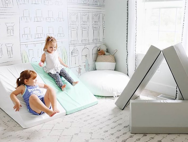 Two children playing on Foamnasium blocksy kid couches in a playroom.