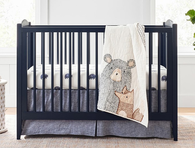 Blue emerson convertible baby crib with bear and fox themed nursery decor.