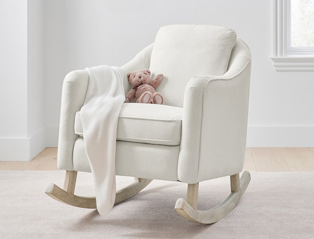 Ivory Muir Rocker chair with blanket and stuffed animal.