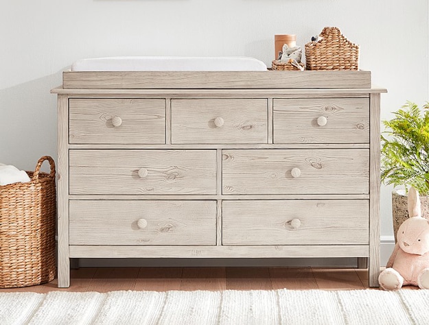 Weathered white Kendall Extra Wide Nursery Dresser and Topper Set in nursery room.