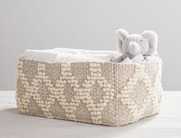 Metallic Woven Wool Nursery storage basket with toys and spare diapers.