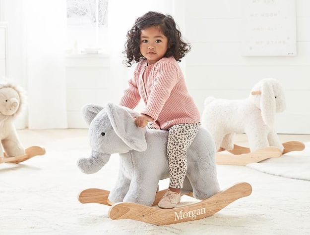 Little girl riding the Elephant Critter Nursery Rocker.