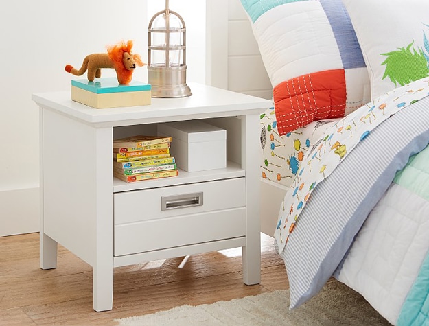 Emery Nightstand with a stuffed lion and set of books styled on top.
