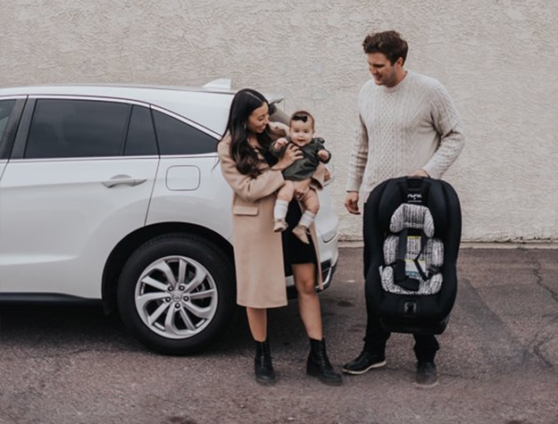 Parents holding happy baby before trip