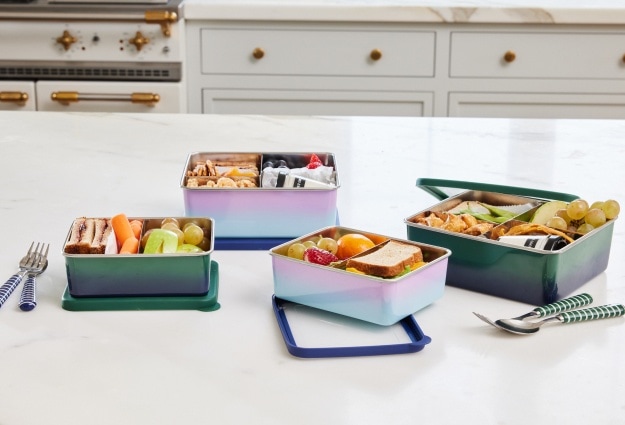 A group shot of the Spencer Stainless Rectangle Bento Box; showing the different ways you can pack and store your child’s lunch within the bento container.