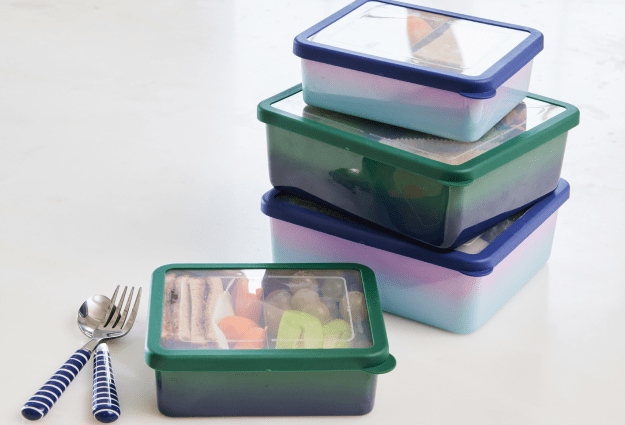 A stack of colorful stainless steel lunch containers