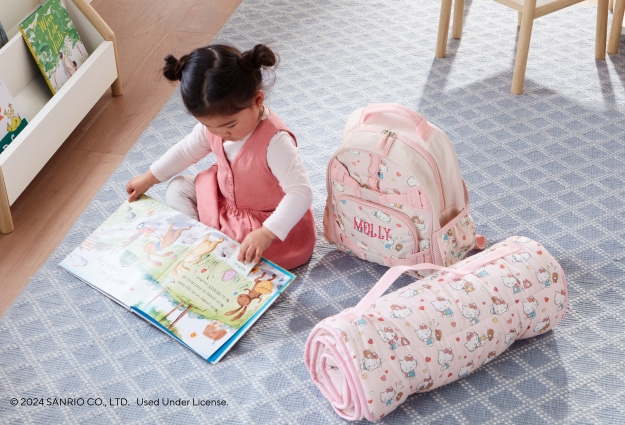 Child sitting down reading a book