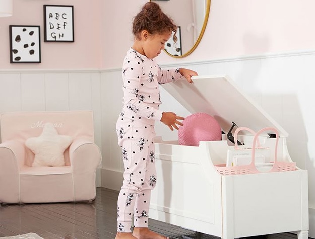 Child opening a storage toy box